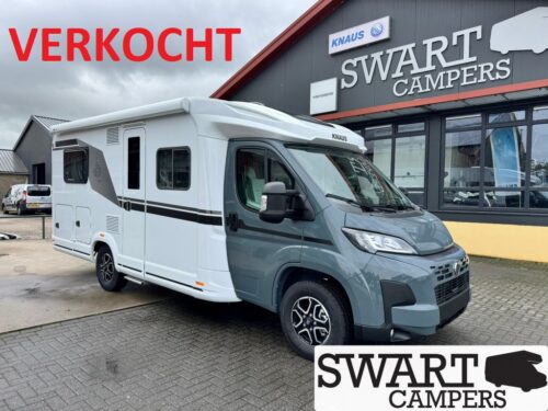 White and gray motorhome parked in front of Swart Campers showroom with a red VERKOCHT banner touchpoint the sold status.