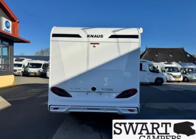 Rear view of a white KNAUS caravan parked on a dealership lot, SWART CAMPERS logo visible in the corner.