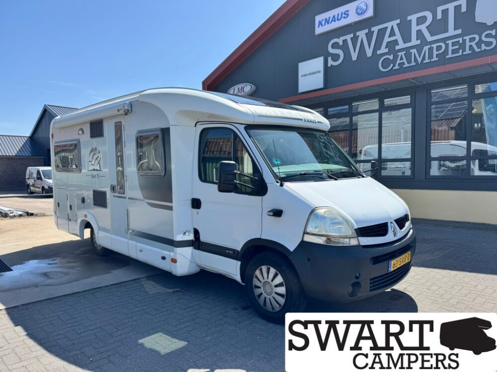 KNAUS SUN TI 650 MF - Swart Campers White camper van parked outside a SWART CAMPERS storefront, with a blue sky and KNAUS branding visible on the roof.