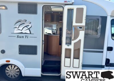 Camper van with Sun Ti branding and open side door, revealing a compact kitchen inside; SWART CAMPERS logo overlapping bottom right.