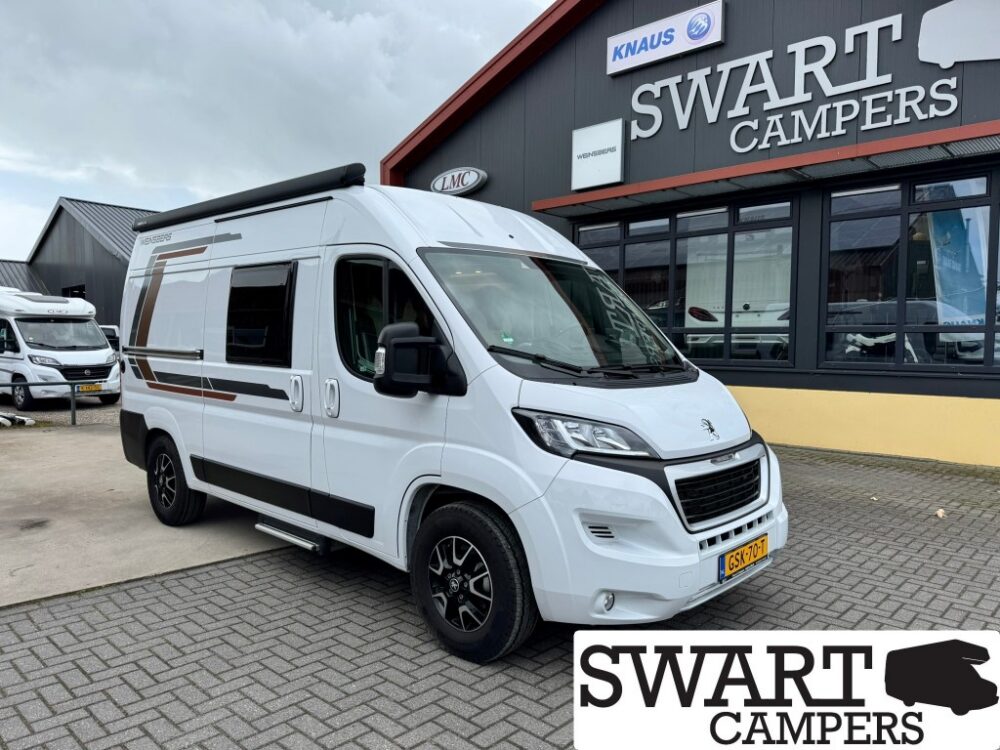 White camper van parked outside a Swart Campers building with large signage. Dutch license plate visible (GS-70-?).