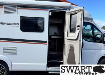 White camper van with the side door open, revealing a compact kitchenette inside; branding on the side reads VENSBERG EDITION [PEPPER], with a Swart Campers watermark in the corner.