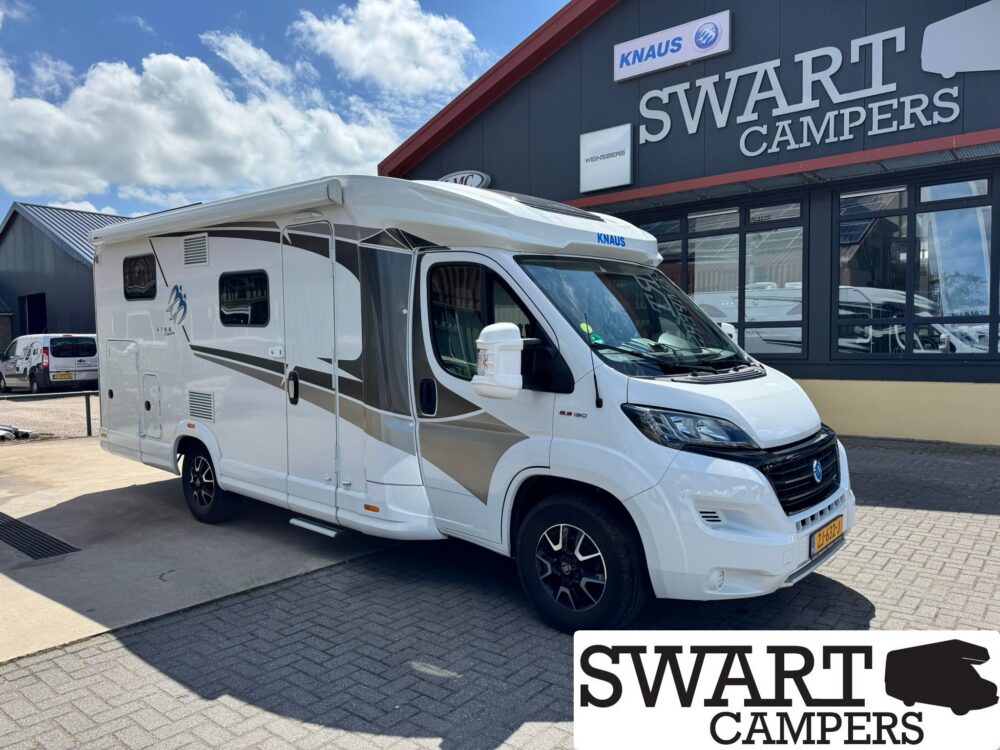 KNAUS LVE TI 650 MEG SELECTION - Swart Campers White motorhome parked outside a camper shop with a large SWART CAMPERS sign in the background. Readable KNAUS logo on the vehicle roof.