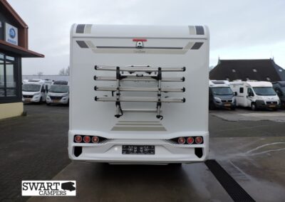 Rear view of a white camper van with a mounted bike rack on the back and the Swart Campers logo in the lower-left corner.
