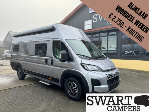 Silver camper van parked outside a showroom with a large sale banner in the top-right corner offering €2,750 discount.
