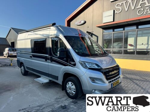 Camper van parked outside a dealership building with SWART CAMPERS logo visible; side step extended and black stripe decals on light gray van.