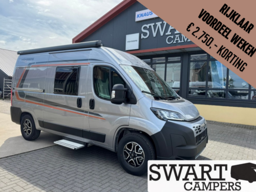 Silver camper van parked outside a Swart Campers showroom; a large brown diagonal banner advertises a €2,750 discount.