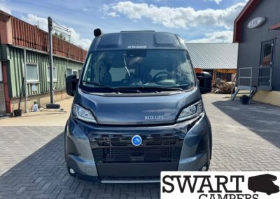 Front view of a dark blue KNAUS Box Life 600 camper van parked in an outdoor lot with a SWART CAMPERS logo overlay in the bottom right corner.