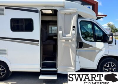 White camper van with its side entry door open and steps extended, revealing the interior seating area; SWART CAMPERS logo visible in bottom corner.