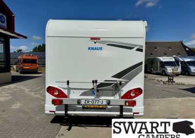 Rear view of a white Knaus camper with a bicycle rack and red tail lights, SWART CAMPERS watermark in the corner, license plate ZR-077-J.