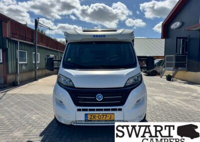 Front view of a white KNAUS camper van in a paved lot, license plate ZR-077-J, SWART CAMPERS watermark bottom right.
