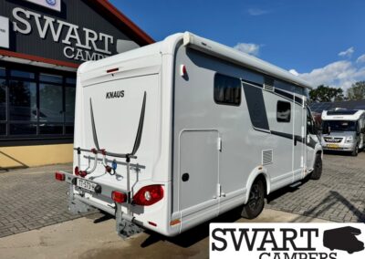 White KNAUS motorhome with rear bike rack, parked outside Swart Campers showroom.