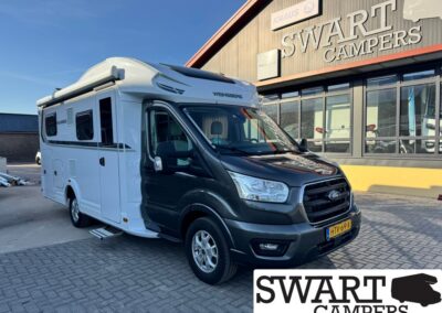 White and black motorhome parked outside a Swart Campers building with large logo sign in the background.