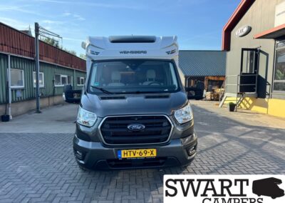 Front view of a gray Ford Weinsberg camper van parked in a dealership yard with a yellow Netherlands license plate (HTV-69-X).