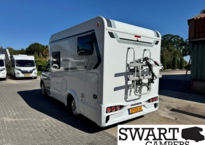 Rear view of a white camper van with a bicycle rack mounted on the back, Dutch license plate visible, parked on a paved lot; Swart Campers watermark in corner.