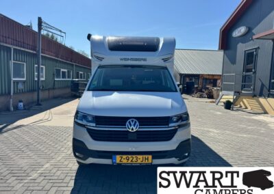 Front view of a white VW camper van with a raised cab roof, parked in a yard; license plate Z-923-JH, SWART CAMPERS watermark.