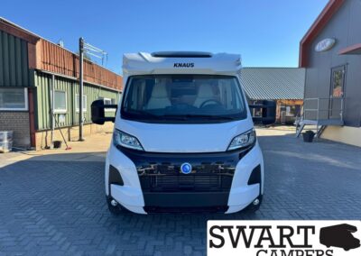 Front view of a white Knaus camper van with large side mirrors, parked on a paved lot; SWART CAMPERS logo in the corner