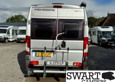 Rear view of a silver camper van with a bike rack, Dutch license plate visible, Swart Campers logo bottom right.