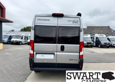 Rear view of a silver Wensberg Carabus Grey 600 ME camper van in a lot with other motorhomes; SWART CAMPERS logo bottom right.