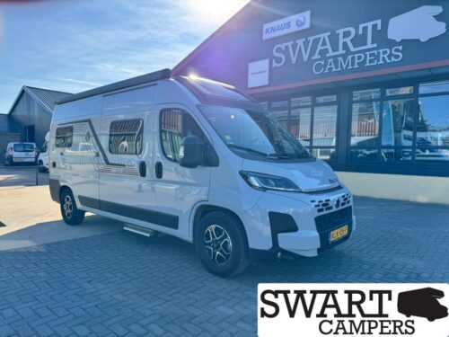 KNAUS BOXLIFE 600 ME PLATINUM SELECTION - Swart Campers White camper van parked outside a Swart Campers showroom, with the building’s SWART CAMPERS sign visible above.