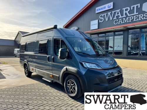 WEINSBERG CARABUS GREY 630 ME EDITION FIRE - Swart Campers Front-right view of a modern gray camper van parked outside a Swart Campers showroom with large sign in the background.